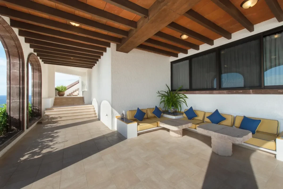 Outdoor seating area at How to Get from SJD Airport to Your Cabo Hotel: Transfers, Areas and Check-In Times under beamed