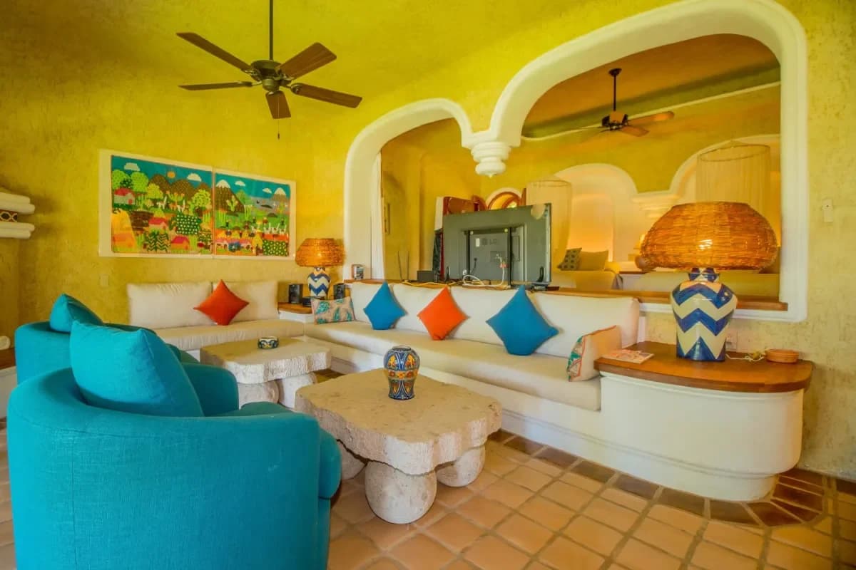 Living room 2 at Your Ultimate 2026 Guide to an All-Inclusive Villa Rental in Cabo with stone table, colorful pillows