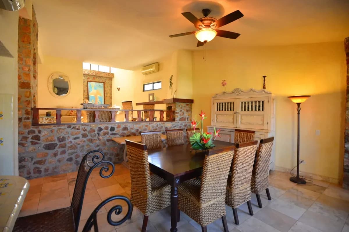 Dining room at Experience Cabo's Pulse: Your Luxury Villa Near Marina Nightlife 2026 with ceiling fan, stone accents
