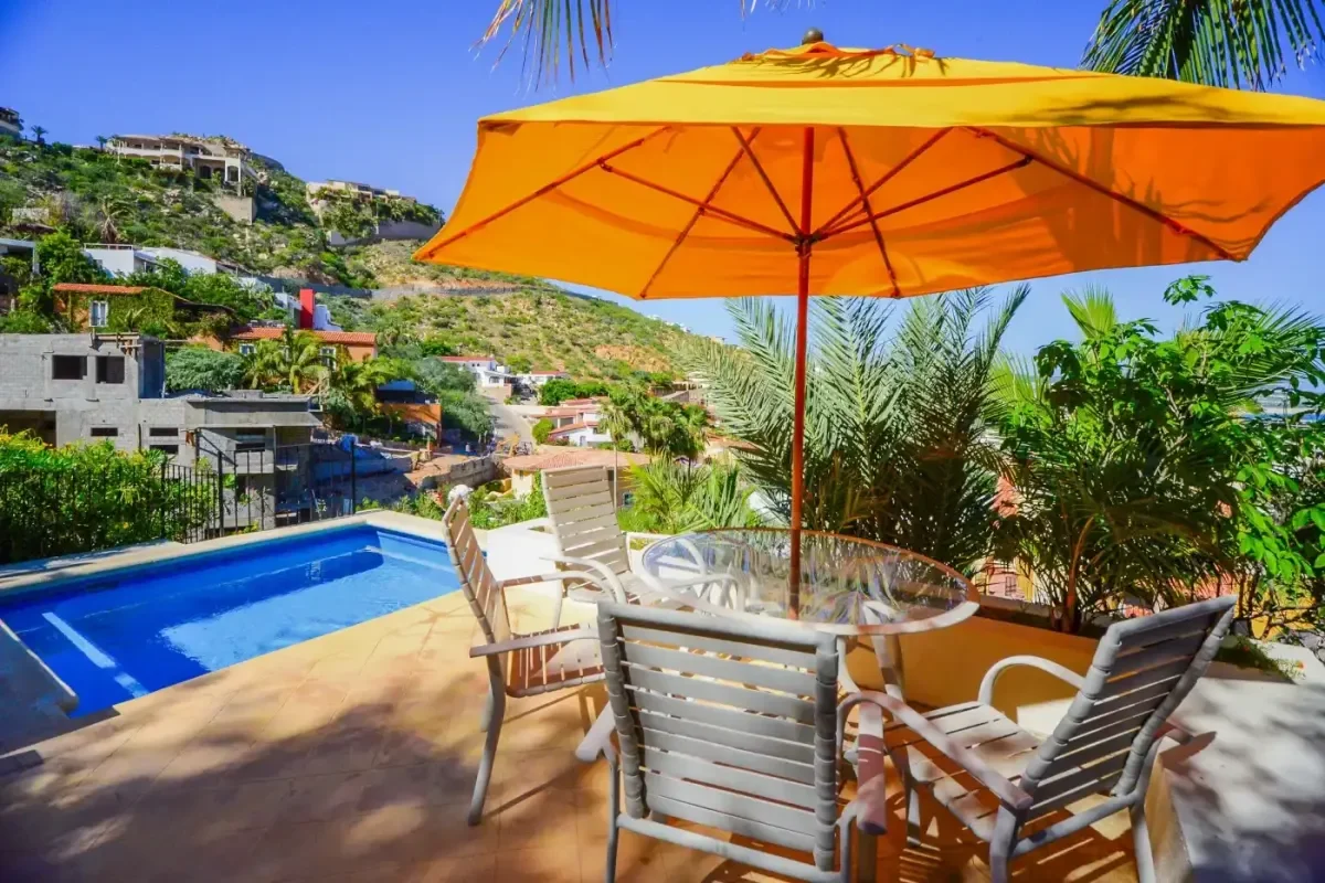 Outdoor dining area 1 at Rejuvenate in Paradise: Best Detox Retreats in Cabo San Lucas 2026 under yellow umbrella, city view