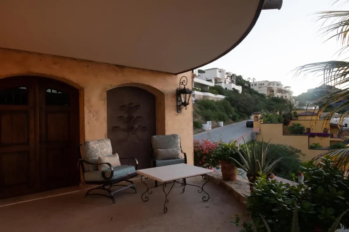 Patio terrace 1 at Crafting Unforgettable Cabo San Lucas Rehearsal Dinner Ideas for 2026 with table, wall lantern