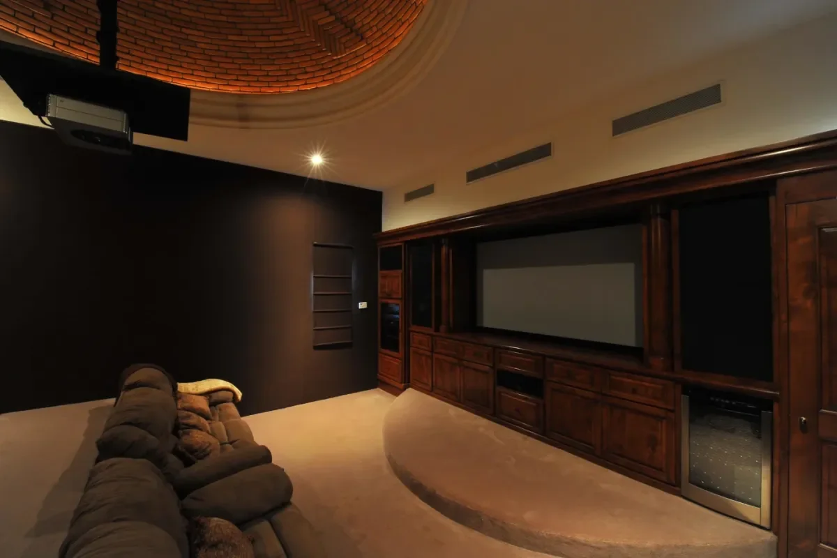 Home theater at Cabo Weather July with large screen and wood cabinetry