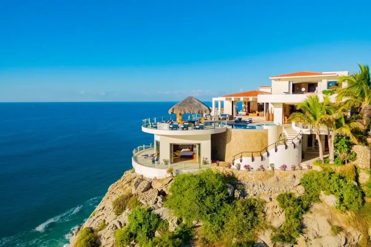 Oceanfront terrace at Villa Penasco with palapa, bedroom below in Pedregal Pacific