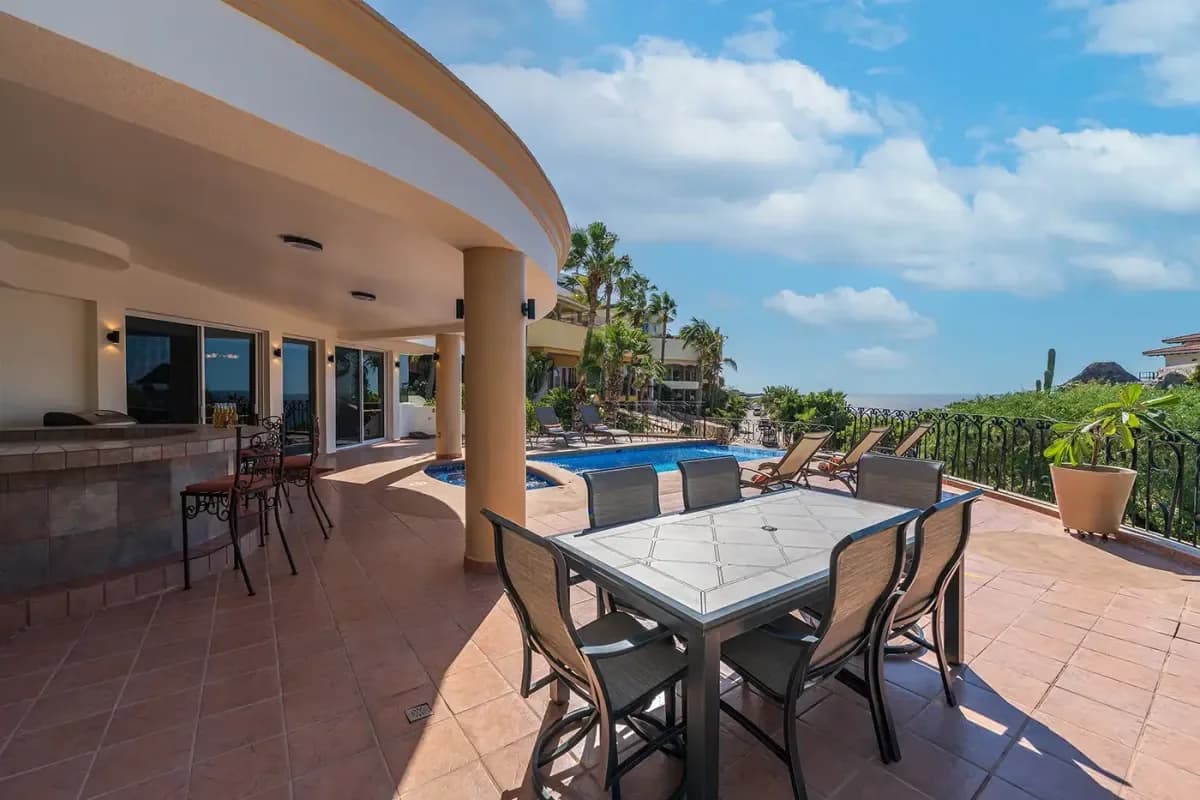 Outdoor dining area at Celebrating Love: Your LGBTQ+ Wedding Guide to Cabo San Lucas 2026 with pool and ocean beyond