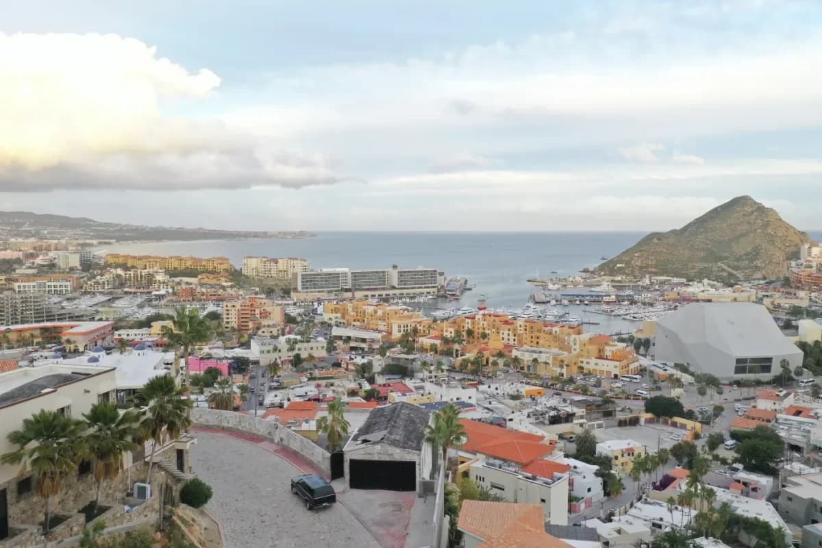 City view at Bella's 2026 Guide: Your Perfect Cabo Catamaran Rental Experience with ocean and buildings, at dusk