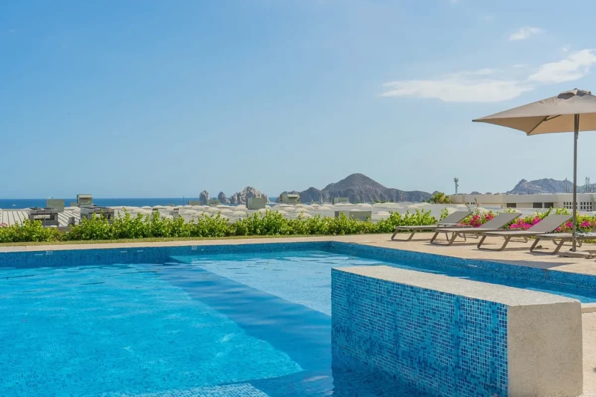 Swimming pool at Chileno Beach Parking with distant hills