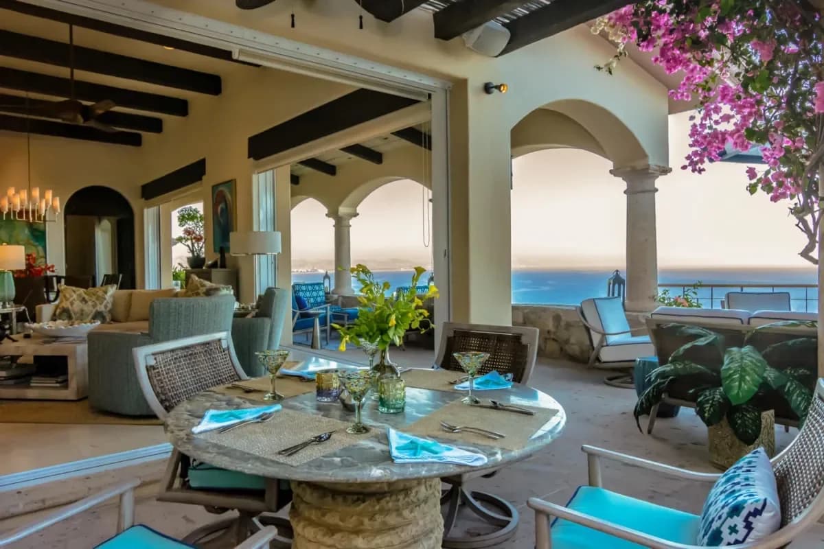 Outdoor dining terrace at Cabo Airport Shuttles: Shared vs Private Comparison with ocean view, set table