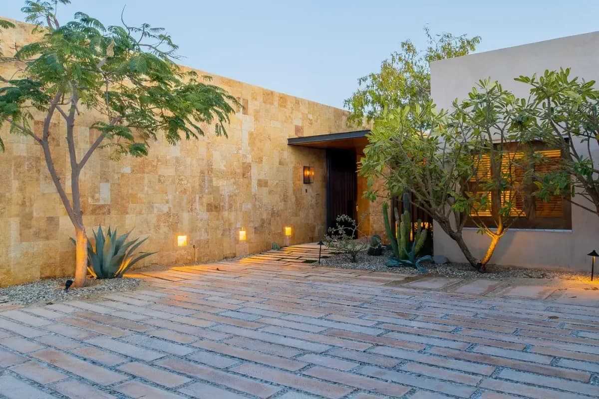Exterior facade at Is Cabo Safe in 2026? Honest Local's Safety Guide stone wall, pathway, at dusk