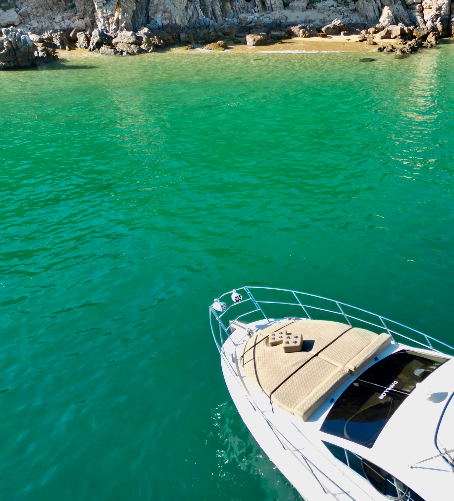 Boat bow on the Azimut 46ft with rocky coastline, green water in Cabo San Lucas (2)