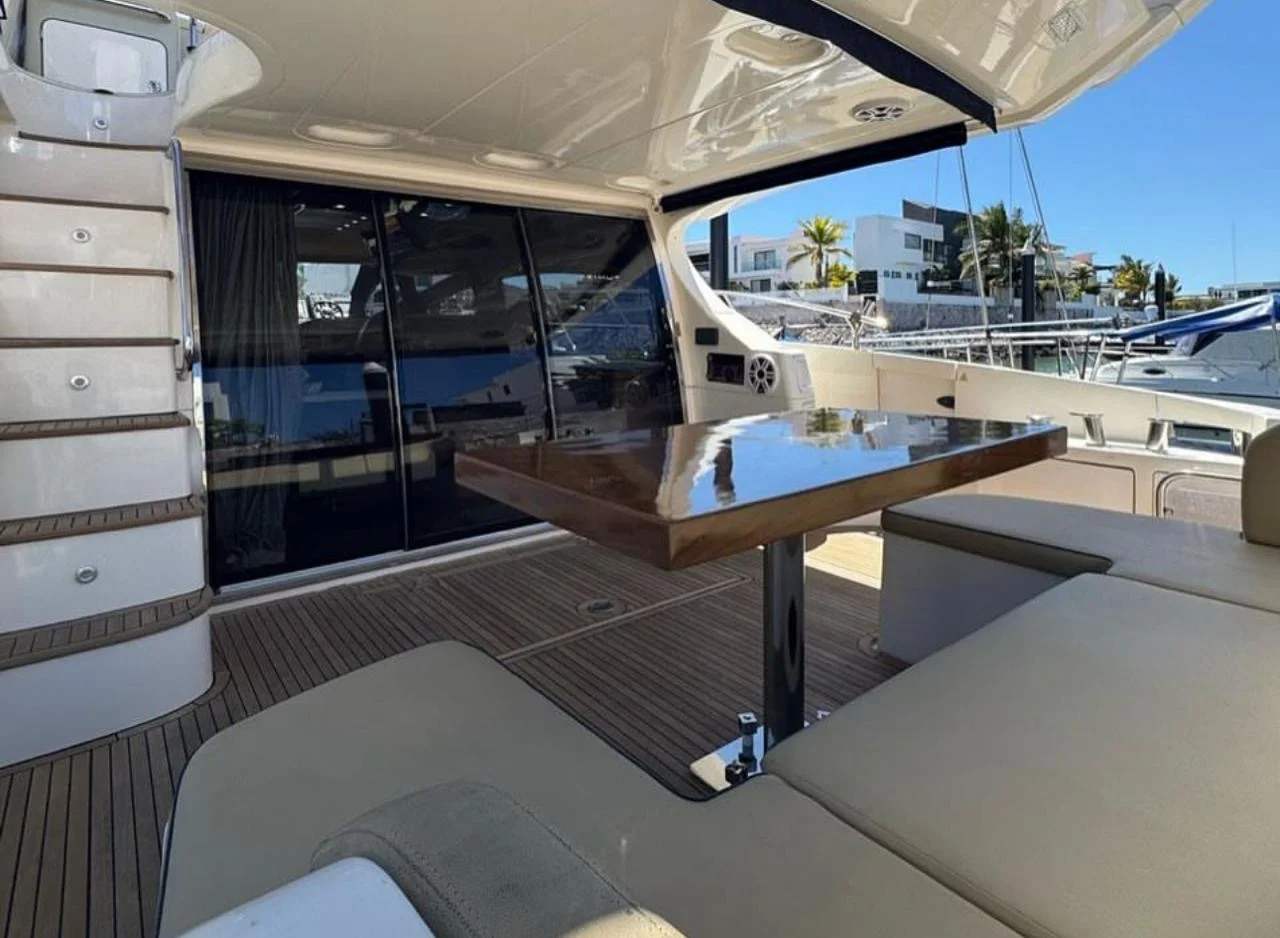 Yacht deck table on the Azimut 68ft with teak flooring, sunny day in Cabo San Lucas