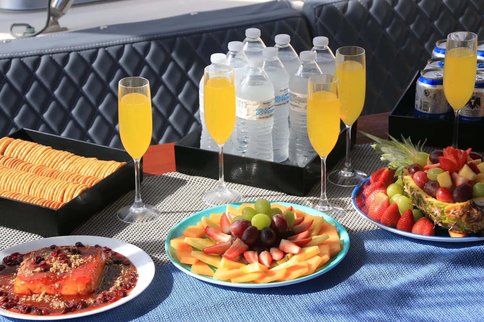 Fruit plate on the Luxury Catamaran Leopard 52ft with drink and water bottles in Cabo San Lucas
