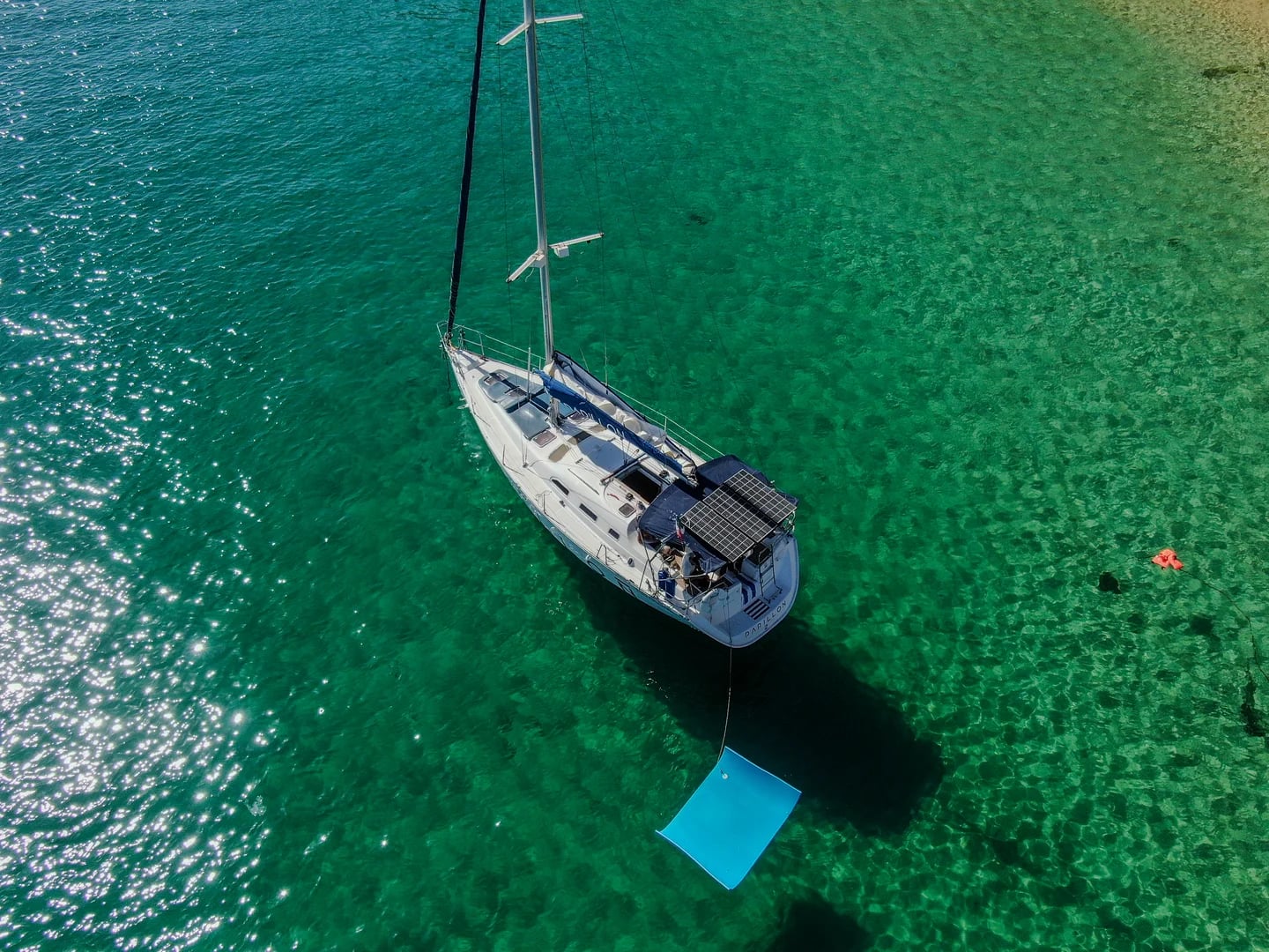Sailboat aerial 2 on the Sailboat 42ft with blue mat, clear water in Cabo San Lucas