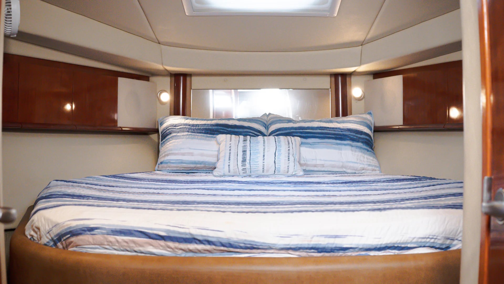 Bedroom bed on the SeaRay Sundancer 45ft blue and white stripes in Cabo San Lucas