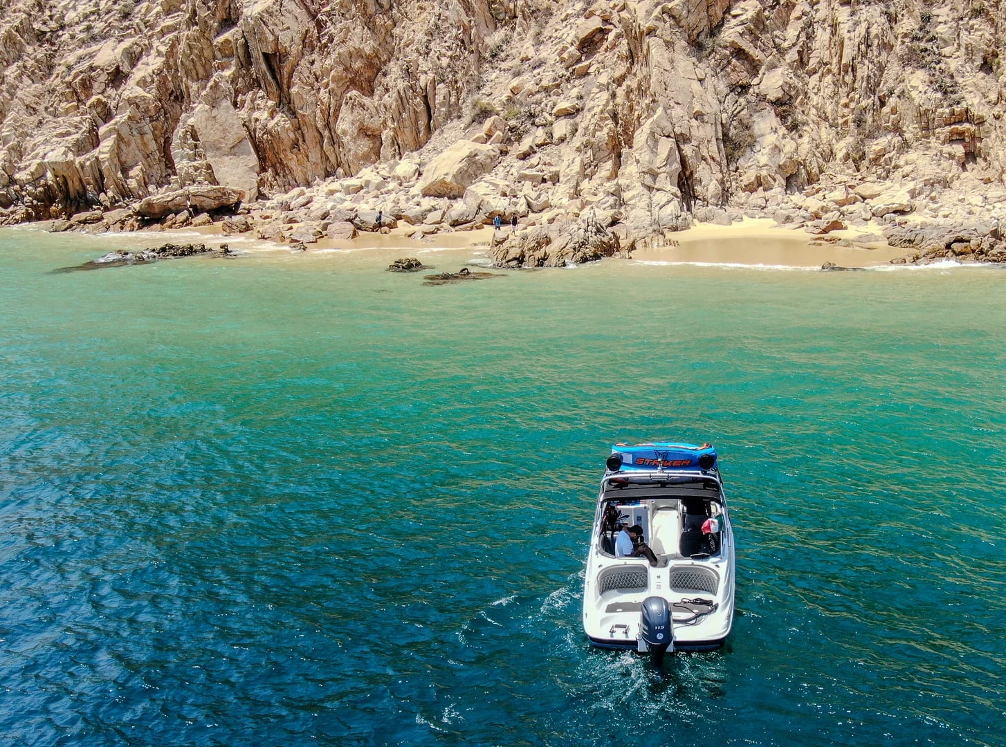 Motorboat 2 on the Yamaha 28ft near rocky beach, clear water in Cabo San Lucas