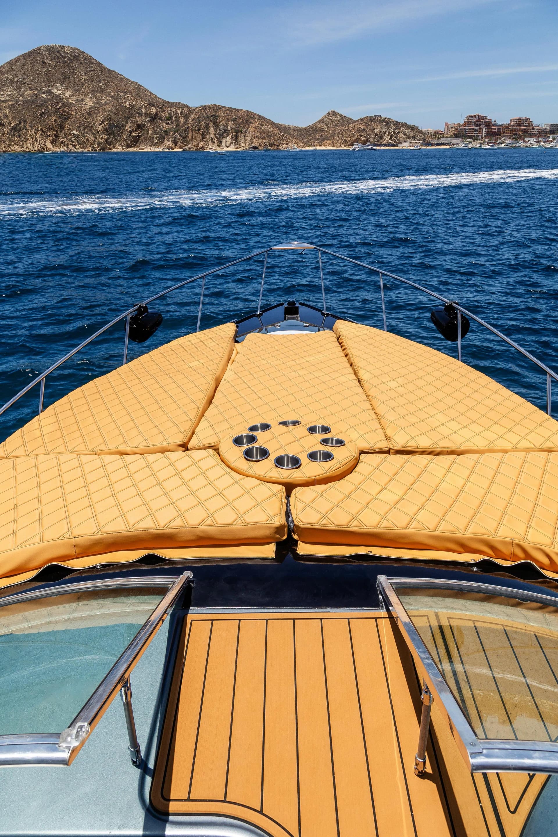 Boat deck at The Best Yacht Experiences in Cabo for 2026 with cup holders, ocean beyond