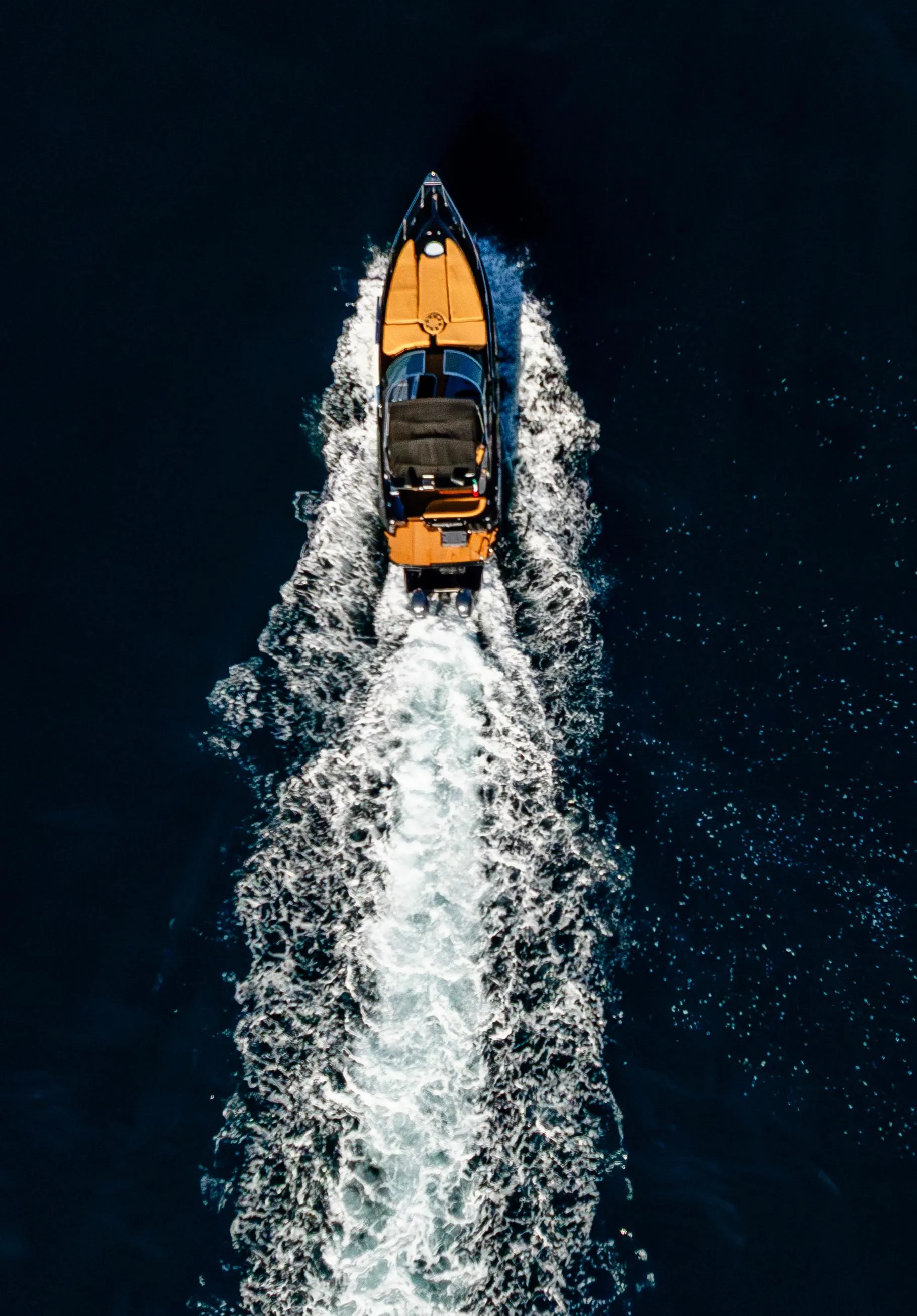 Speed boat on the Yacht Cruiser 37ft aerial from above, leaving wake in Cabo San Lucas